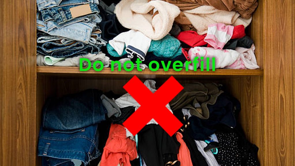 An overfilled wardrobe with a cross through it. Do not overfill.