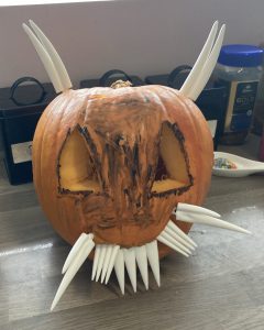 A pumpkin with massive teeth and massive horns.